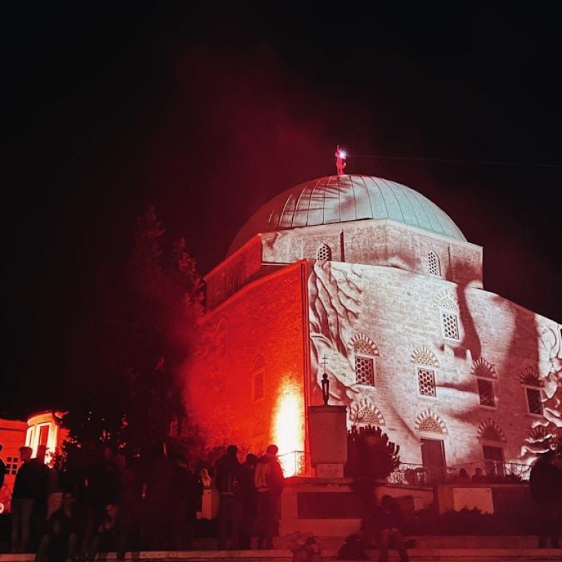 a large building lit up with red lights